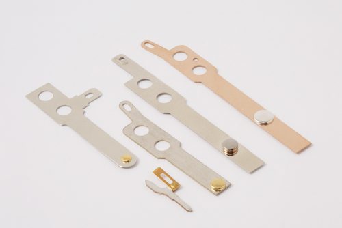 Contact Assemblies, metal strip with electrical contact, custom contact assemblies, contact assembly riveting, riveting contacts to blades, welding contacts to metal blades, electrical contact assemblies, customized contact assemblies, contact blade stamping, contact assemblies with material nickel silver, copper contact assembly, brass contact blade, phosphor bronze contact blade, stainless steel contact blade, contact assembly with brass blade, custom steel stampings, tin steel stampings, thin material stampings, progressive die stamping, punch press punching metals from .003" thick to .25" thick, draw dies, secondary dies, perforating, stampings up to 8" wide