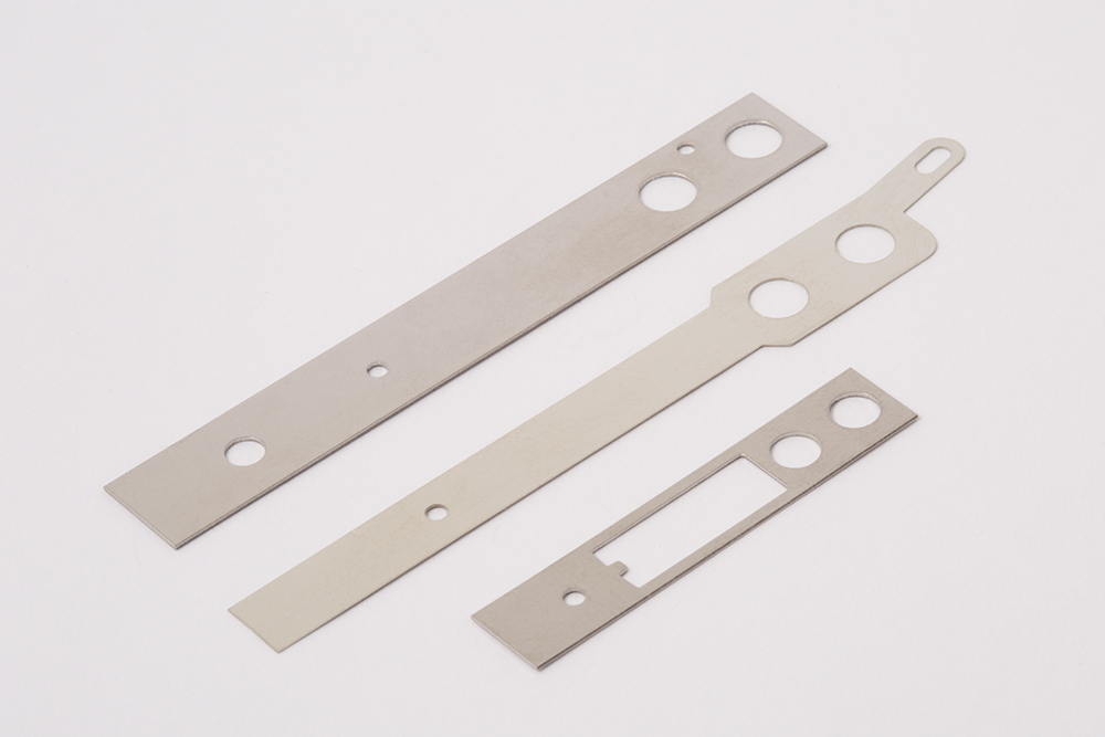 switch blades, affordable tooling, thin metal stampings, thin nickel silver stamping, copper, brass, phosphor bronze, thin stainless steel stamping, brass, steel stampings, tin steel, thin material stampings, progressive die stamping, punch press punching metals from .003" thick to .25" thick, draw dies, secondary dies, perforating, stampings up to 8" wide,custom zinc plated brackets, affordable tooling, large metal stampings, nickel silver stampings, nickel silver brackets, custom nickel silver strips, copper stampings, copper brackets, custom copper bracket stamping, custom copper brackets, brass stampings, custom brass brackets, phosphor bronze stampings, phosphor bronze metal strip stamping, phos. bronze metal strip stamping, stainless steel stampings, brass stampings, custom brass strip punching, steel stampings, steel bracket stamping, CRS bracket stamping, tin steel stampings, thin metal stampings, progressive die stamping, punch press, punching metals from .003" thick to .25" thick, draw dye stamping, secondary dye stamping, metal perforating service, stampings up to 8" wide, metal punching service Chicago, punching service Chicago, custom stampings Chicago, short run stampings, small metal stamping, precision stamping chicago,