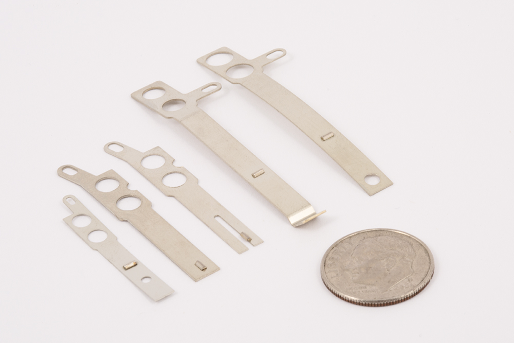 electrical contact assemblies with .010" nickel silver metal strip with spot welded electrical contact wire, custom contact assemblies with custom contact blade stamping, thin material stampings, progressive die stamping, secondary dies, Spot welded electrical contacts made of precious metal palladium wire 100% PD